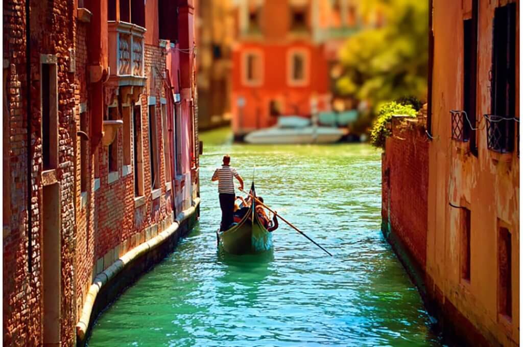 A gondola driver on a side canal in Venice.