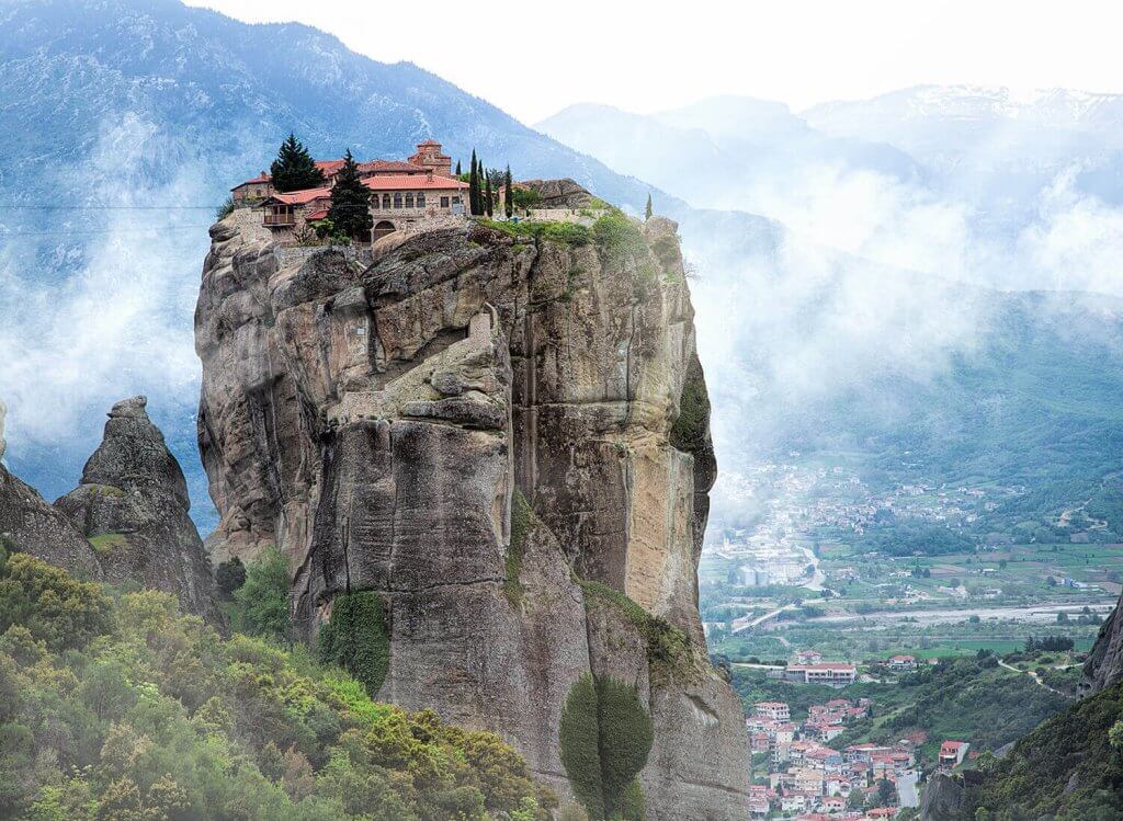 A giant rock with the monasteries of Metéora in Greece with cloudy sky.