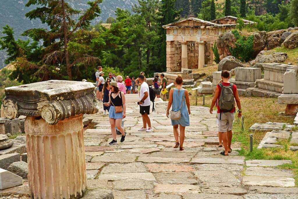 Tourist walking around at the temple of Delphi.