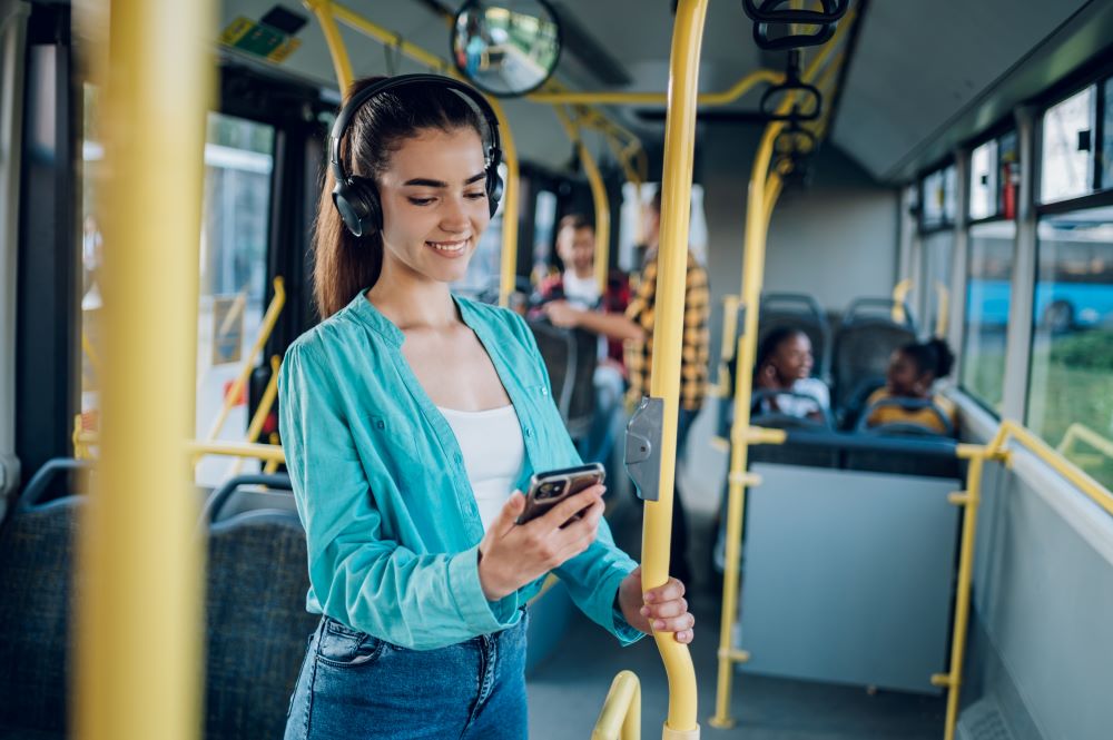 A young woman in a public transport bus.