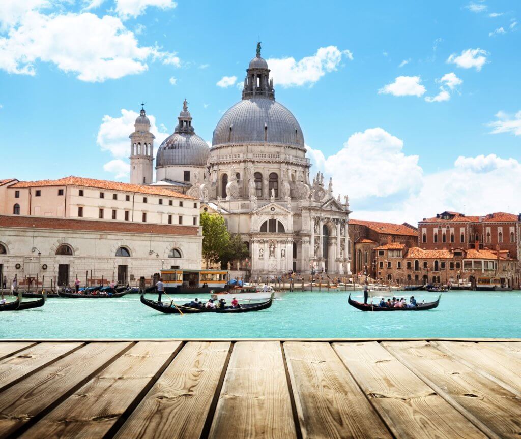 Basilica of Santa Maria in Venice with the turquoise canal and two gondolas in front of it