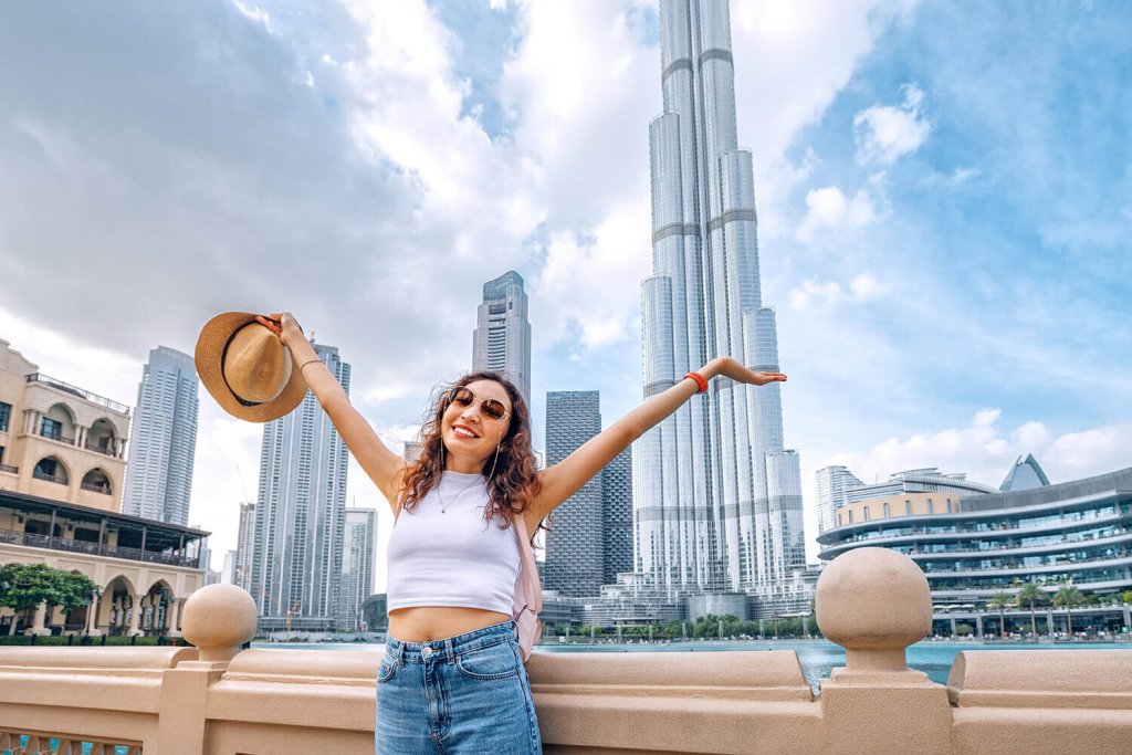 Happy Girl infront of Burj Khalifa on a sunny day.