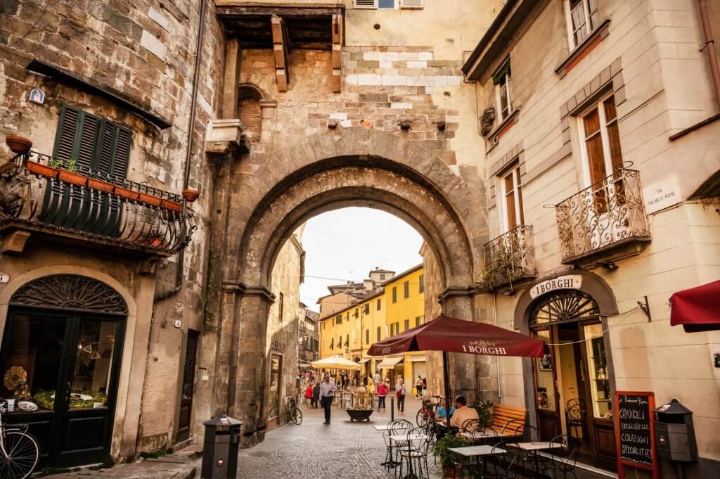 Large round arch made of stone in the medieval town of Lucca.