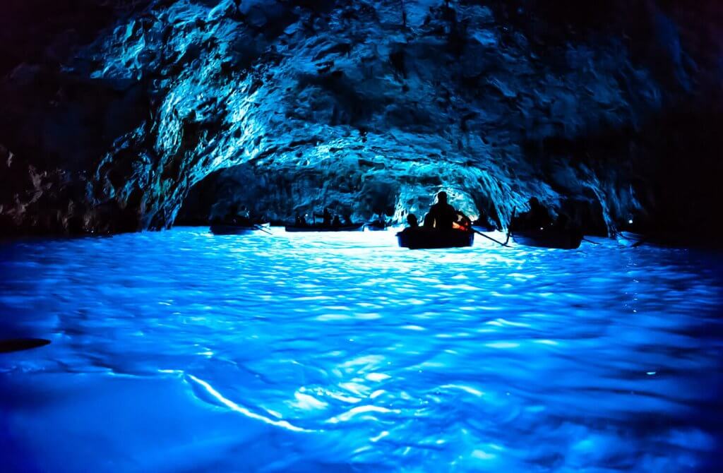 The Blue Grotto from the inside with bright blue water.