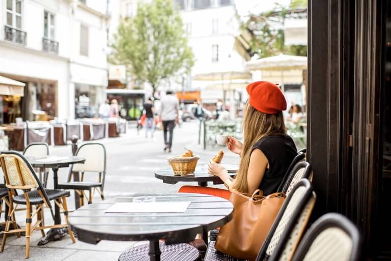 Woman sitting in a terrace of an café having a coffee.