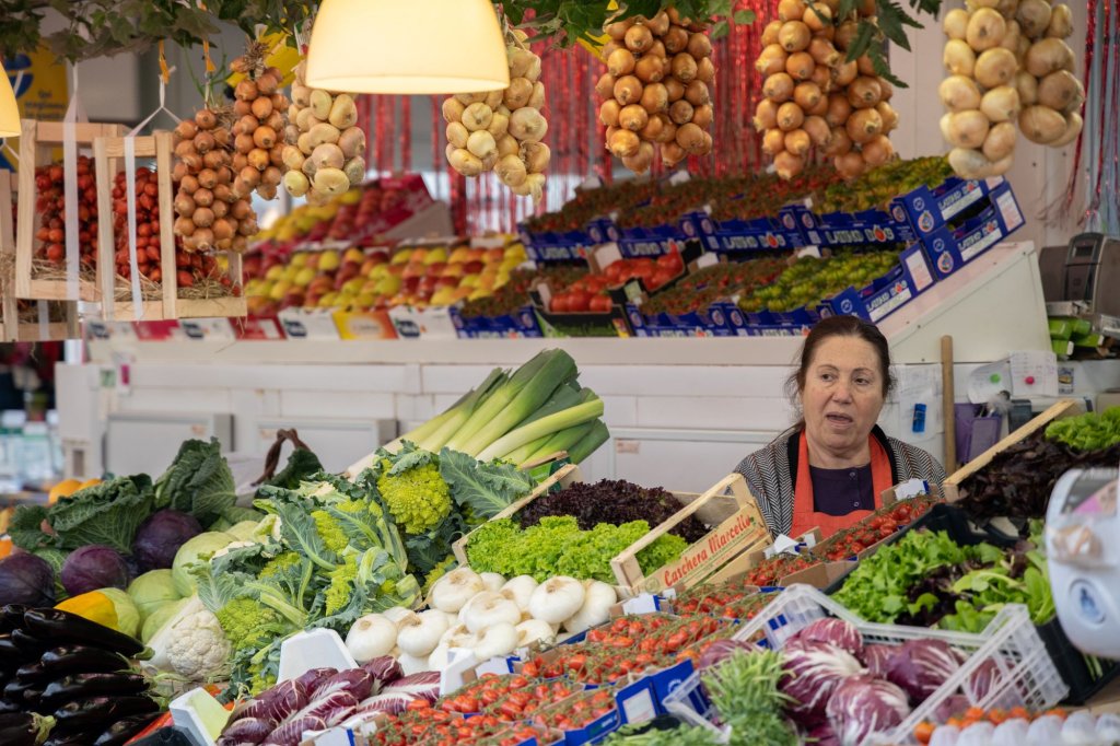 A woman selling vegetables in the Mercato di Testaccio in Rome.