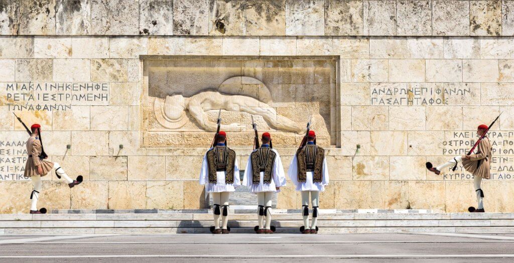 Panoramic view of changing of honor guard on Syntagma square. Presidential guard in traditional uniform are marching in front of Tomb of Unknown Soldier in city center.