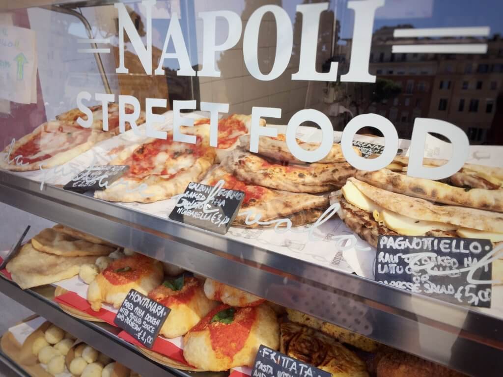 Food market on Neapolitan Street. Calzone fritto, pagnottiello and pizza among the traditional dishes on sale