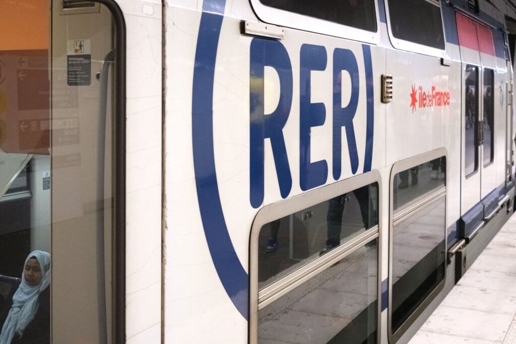 A RER passenger train car at a station in Paris.