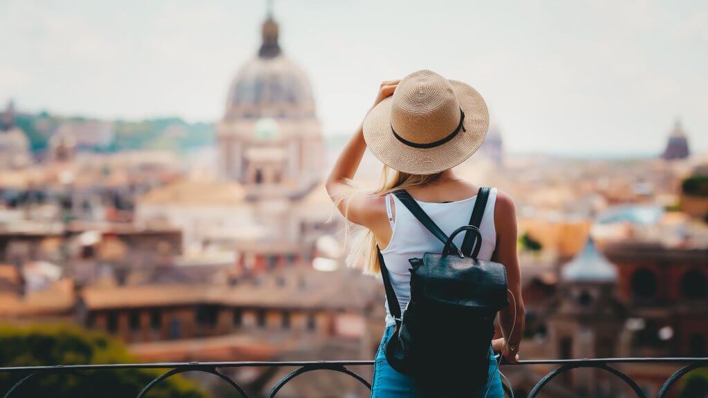 A young tourist looks at theSt. Peter's Basilica in Rome from a vantage point.