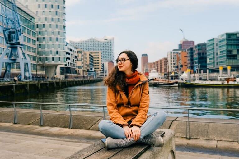 Girl sitting infront of Speicherstadt Hamburg