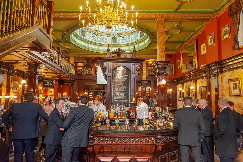 Men in suits in a traditional Pub in London.