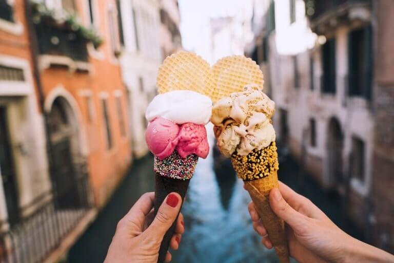 Two ice creams with a canal in Venice in the background