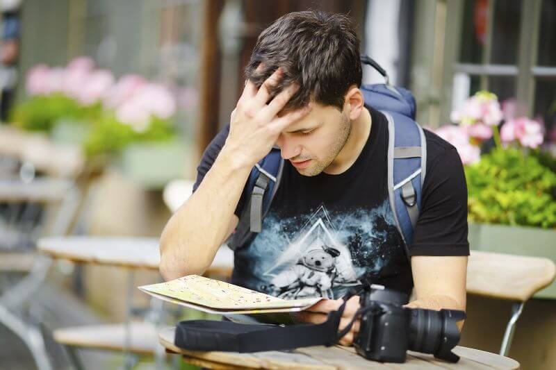 Confused traveler looking at notes