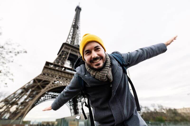 Young man in front of the Eiffel Tower